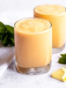 Two cups of mango pineapple smoothie.