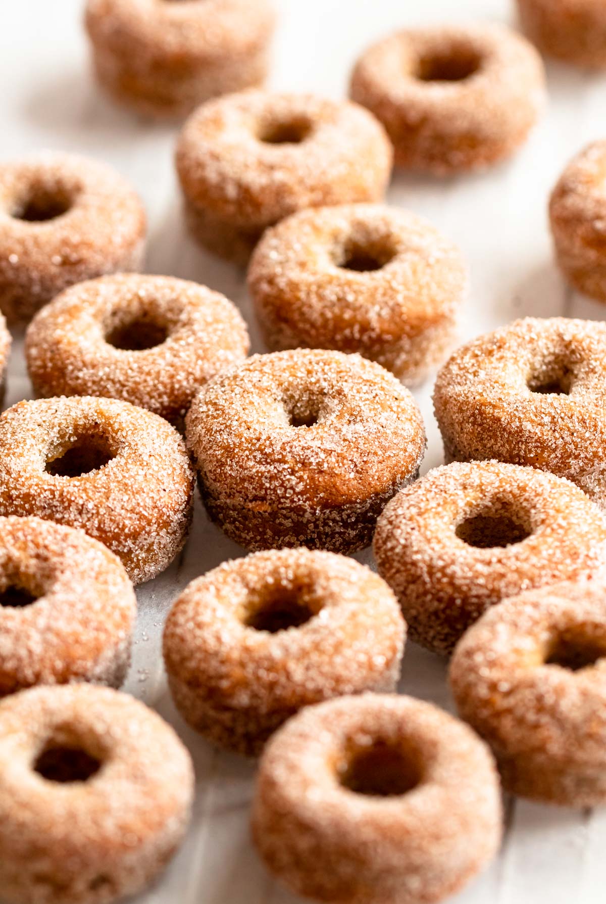 Mini donuts on a parchment paper.