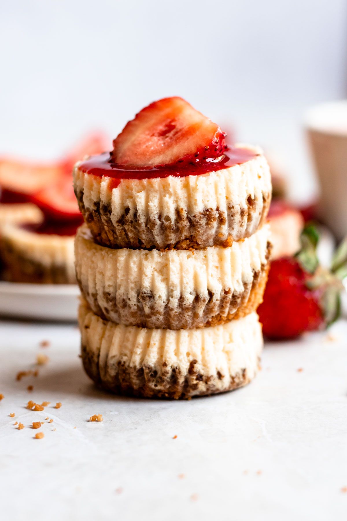 Stack of 3 mini strawberry cheesecakes.