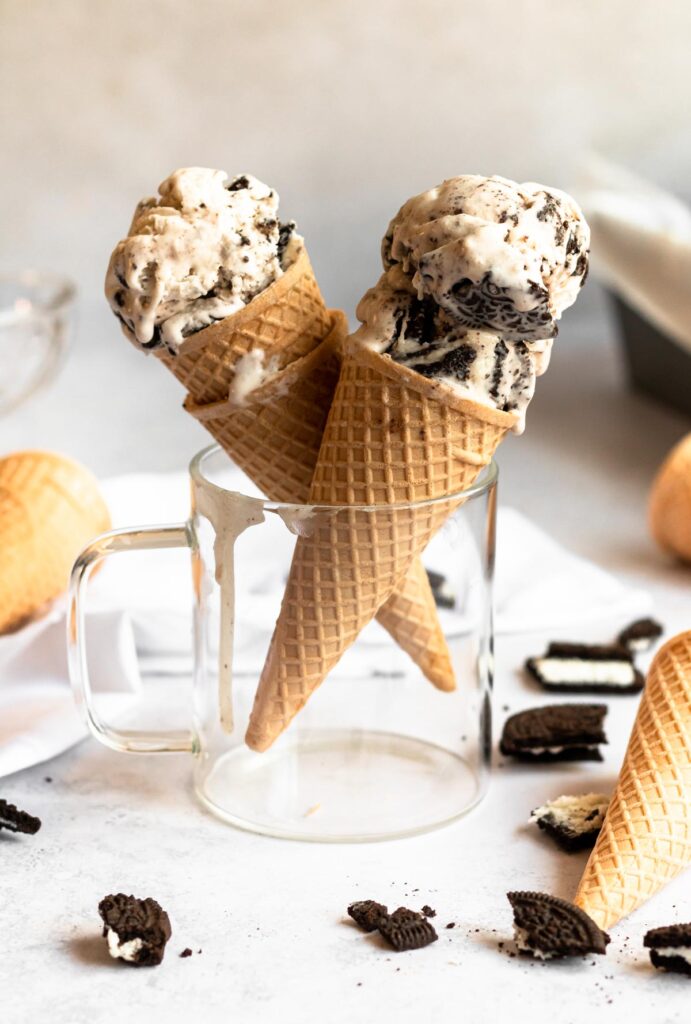 Two ice cream cones in a glass.