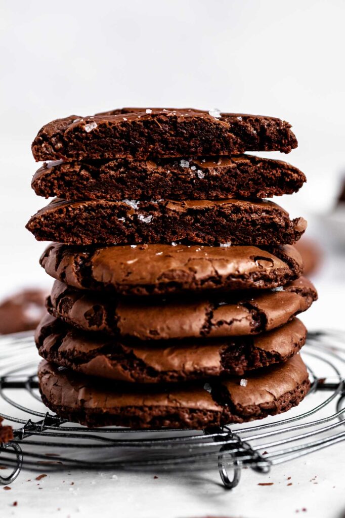 A stack of brownie cookies on a round cooling rack.