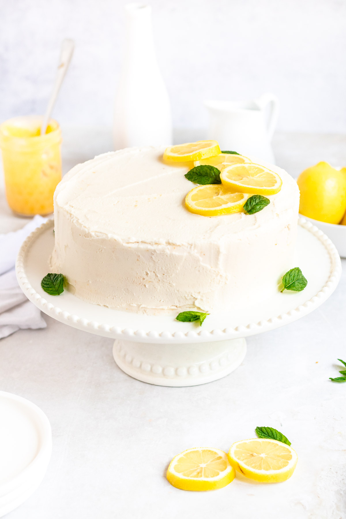 Lemon curd cake on a white cake platter.