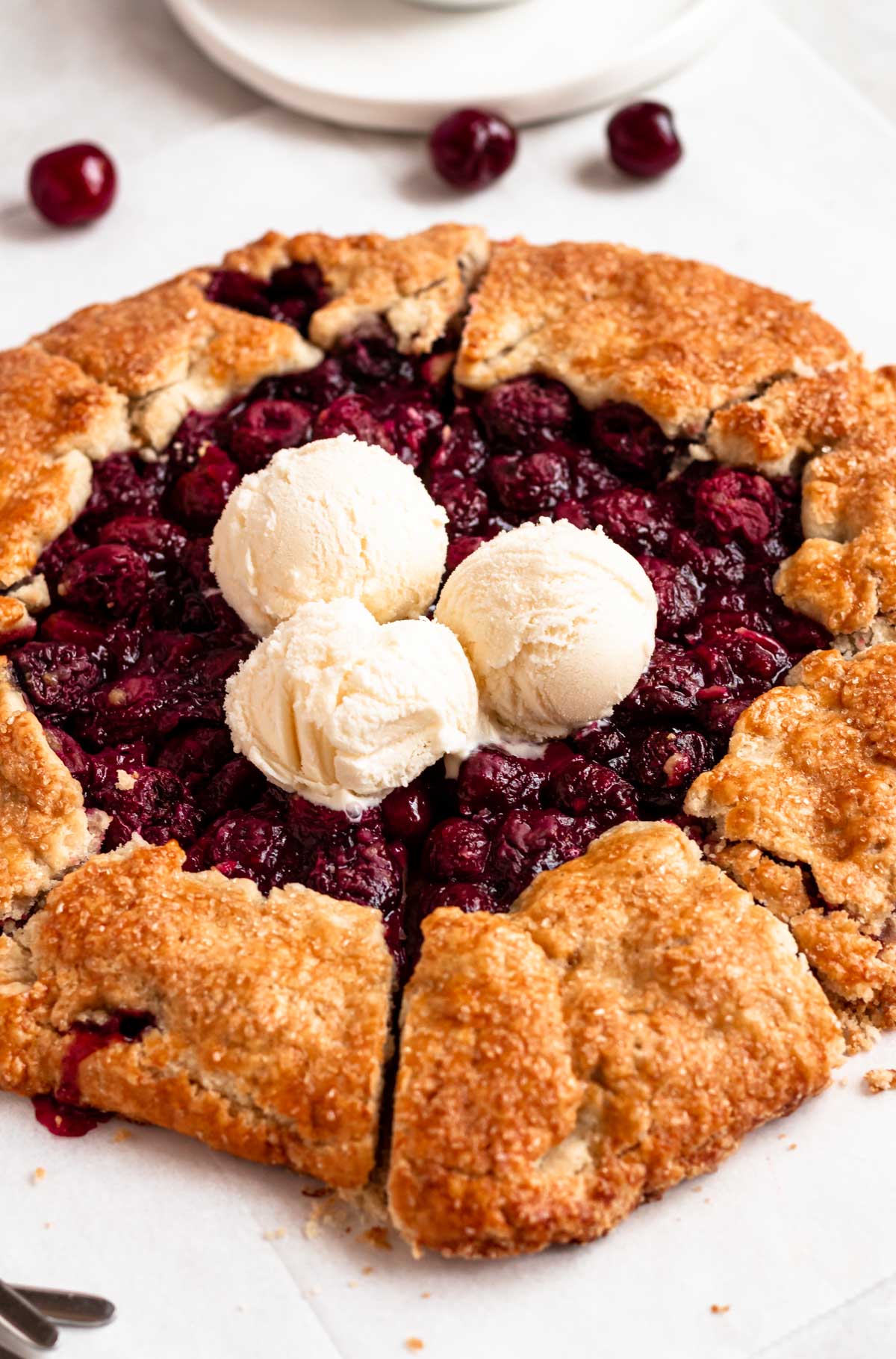 Overhead shot of cherry galette with ice cream.
