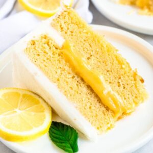 Slice of lemon curd cake on a white plate.