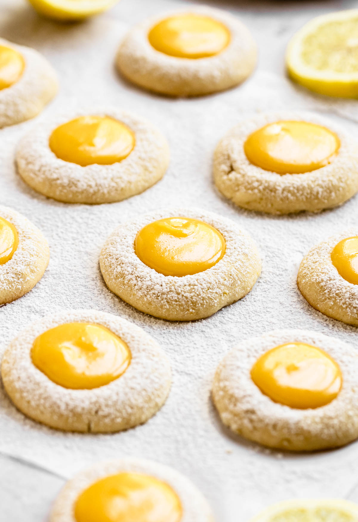 Lemon curd cookies on a white parchment paper.