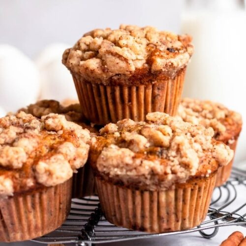 Stack of pumpkin banana muffins on a cooling rack.