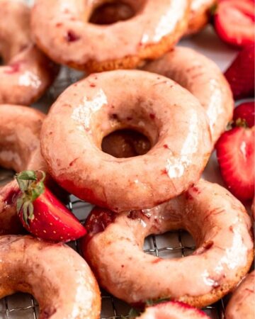 Close up shot of strawberry glazed donuts.