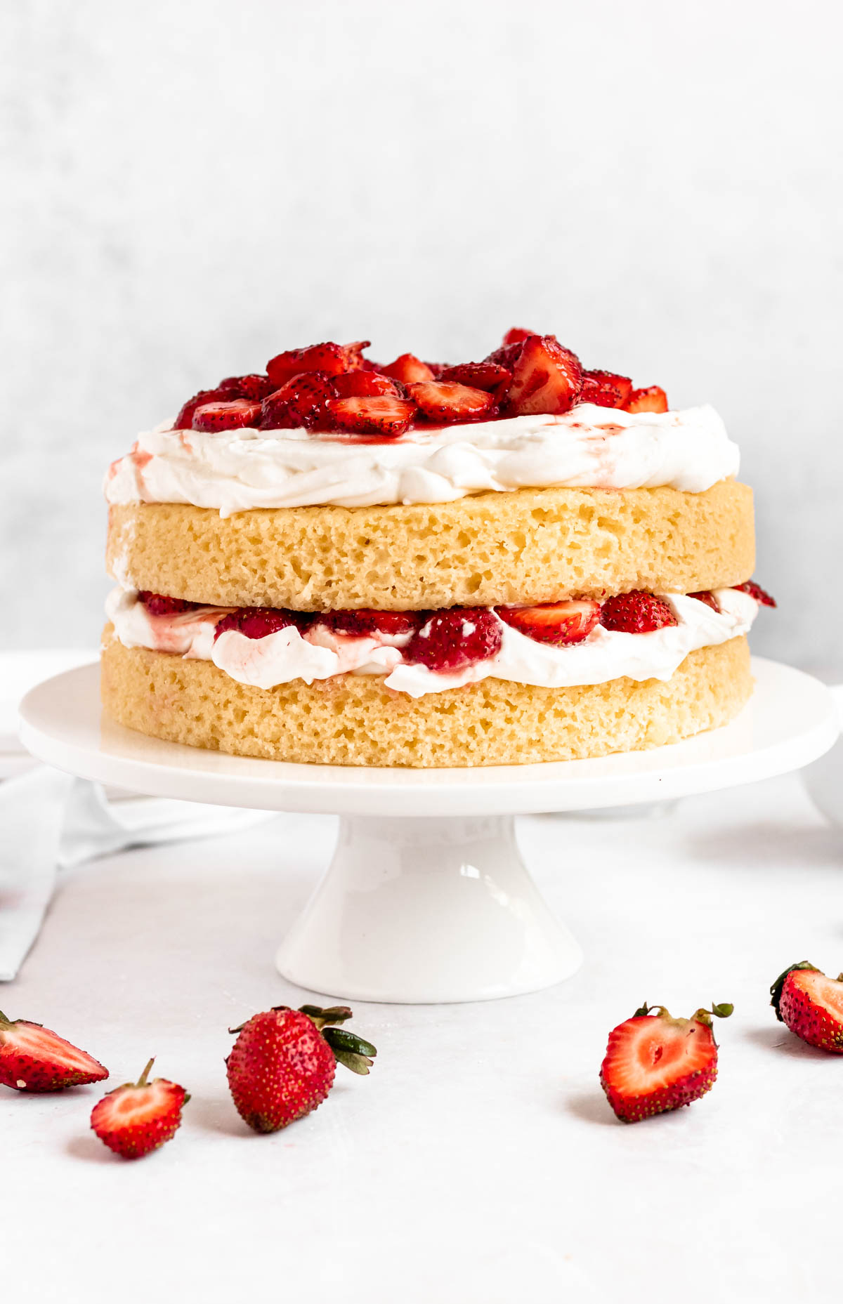 Strawberry shortcake cake on a cake platter.