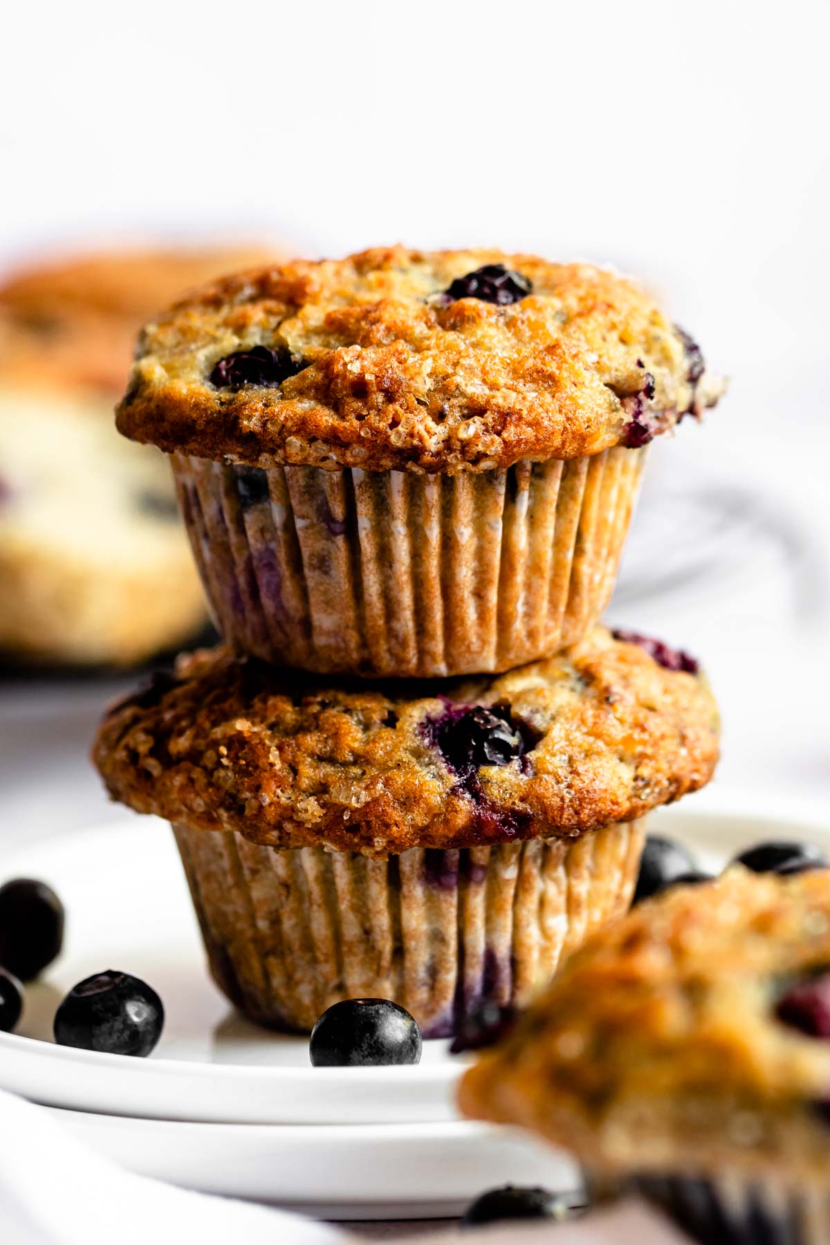 Stack of two blueberry banana muffins on a plate.
