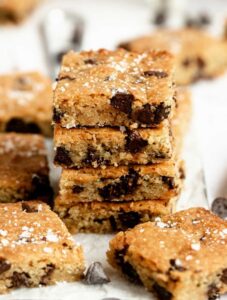Close up shot of a stack of chocolate chip blondies.