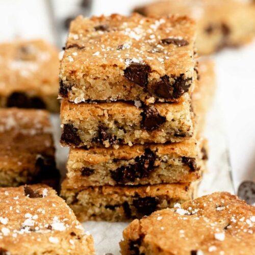 Close up shot of a stack of chocolate chip blondies.