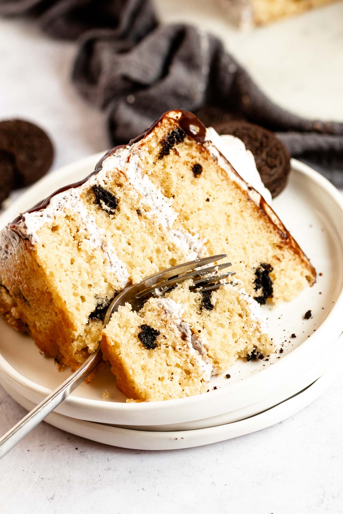 Slice of oreo cake on a white plate.