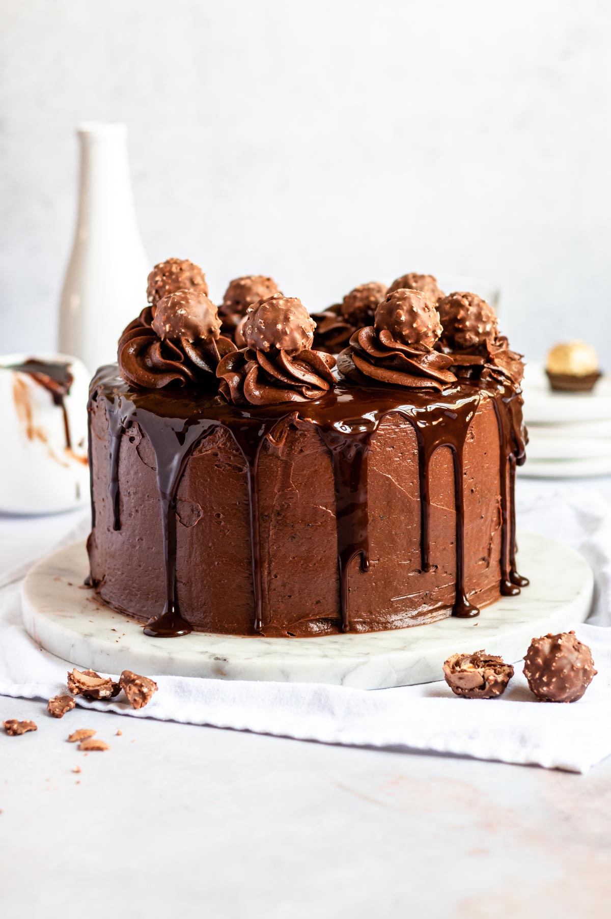 Ferrero rocher cake on a white cake plate.