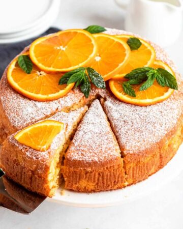 Slice pulled out from an orange cake.