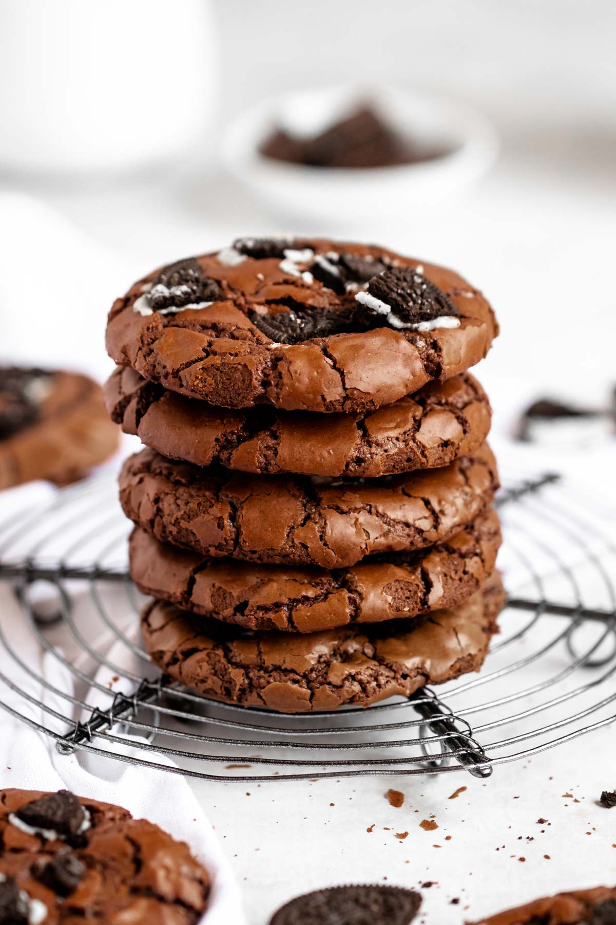 Stack of oreo brownie cookies on a cooling rack.
