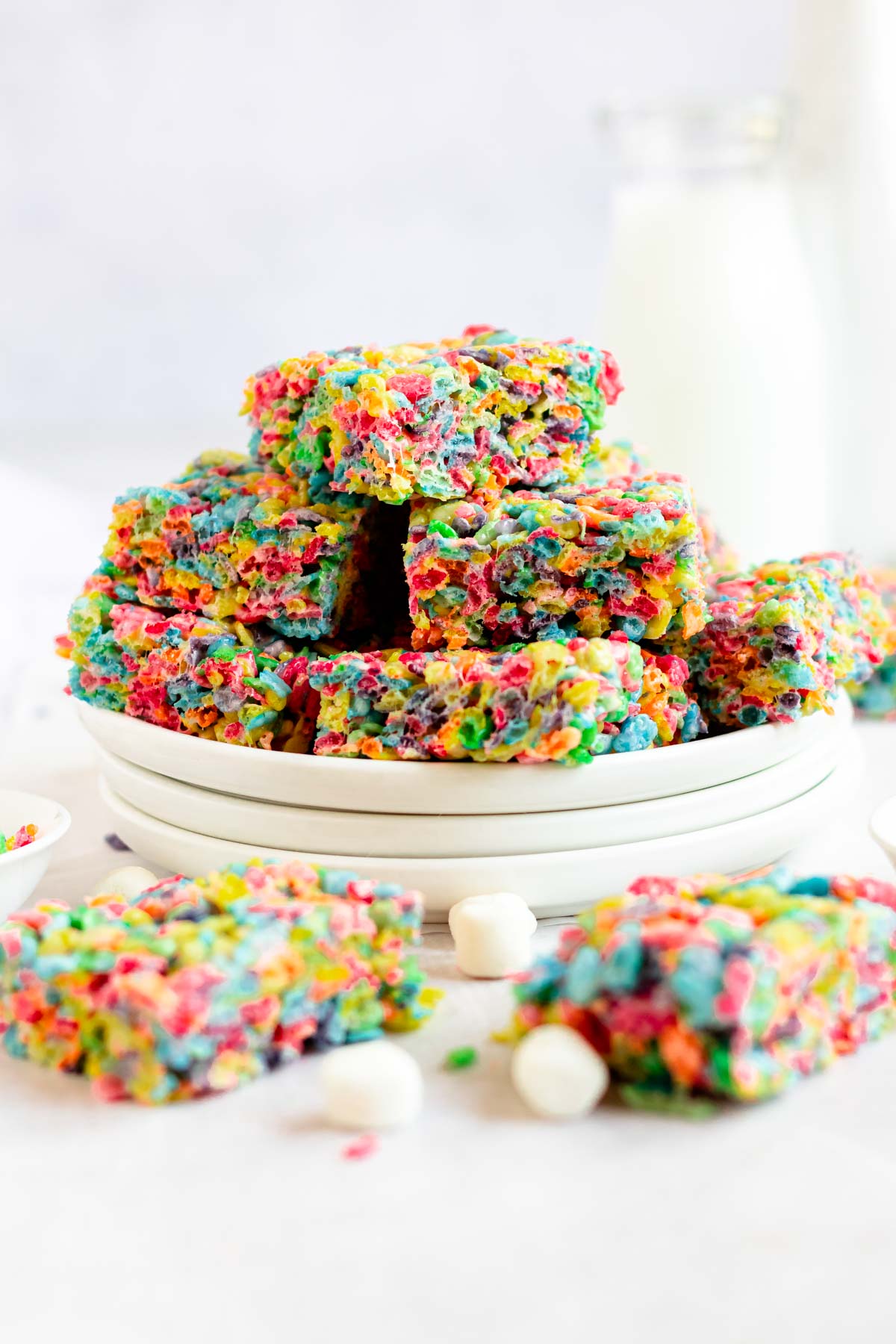 Stack of fruity pebbles treats on a plate.
