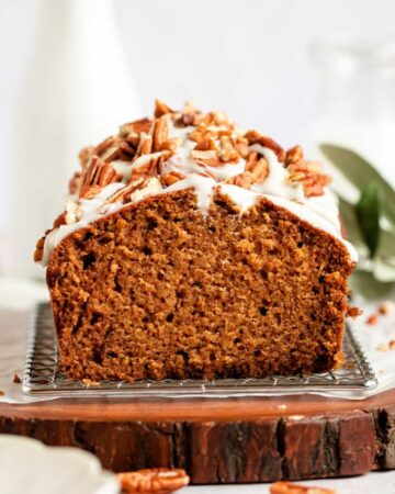 Close up shot of pumpkin bread with cream cheese frosting.