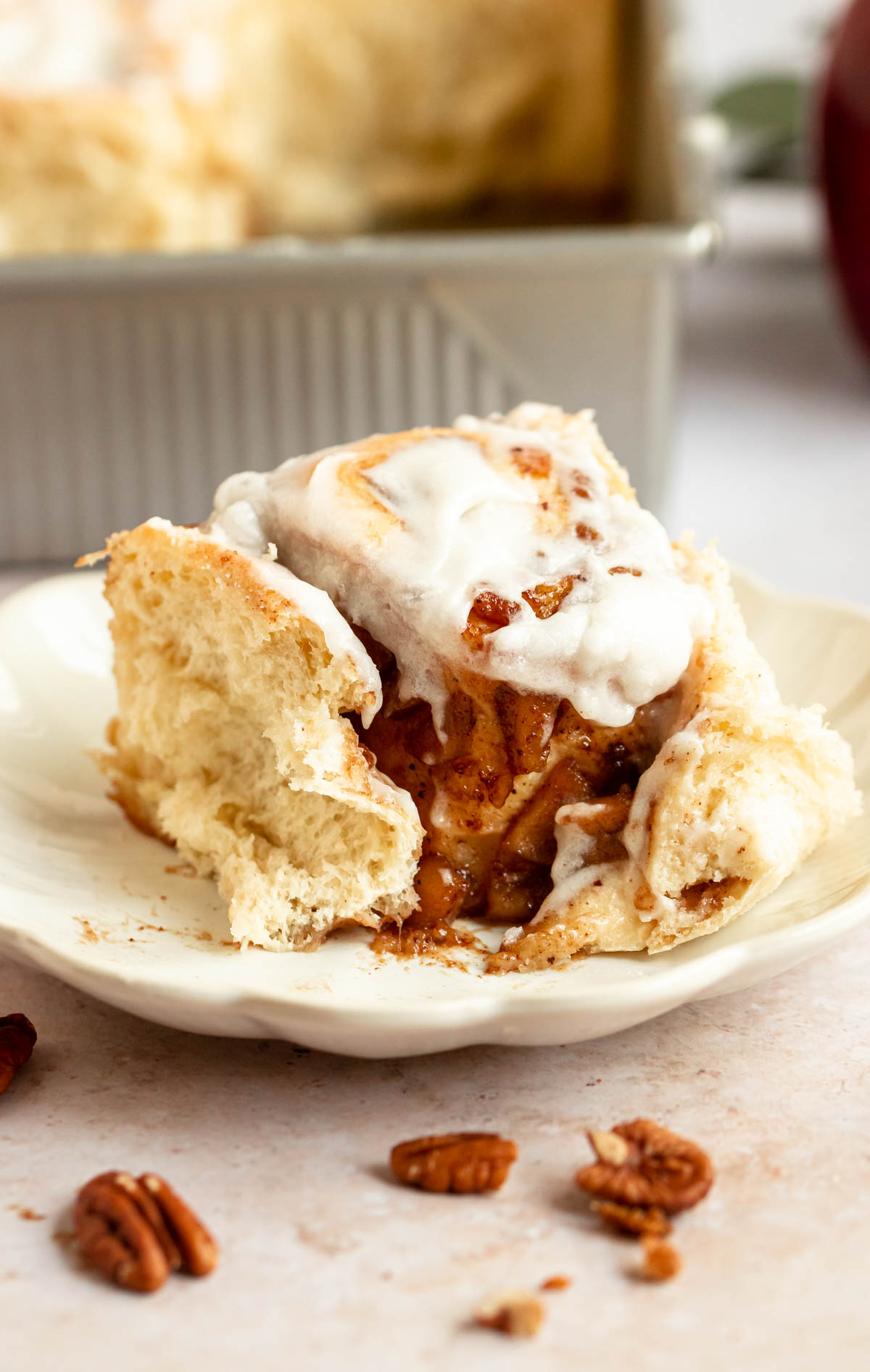 Bite missing from apple cinnamon rolls with apple pie filling.