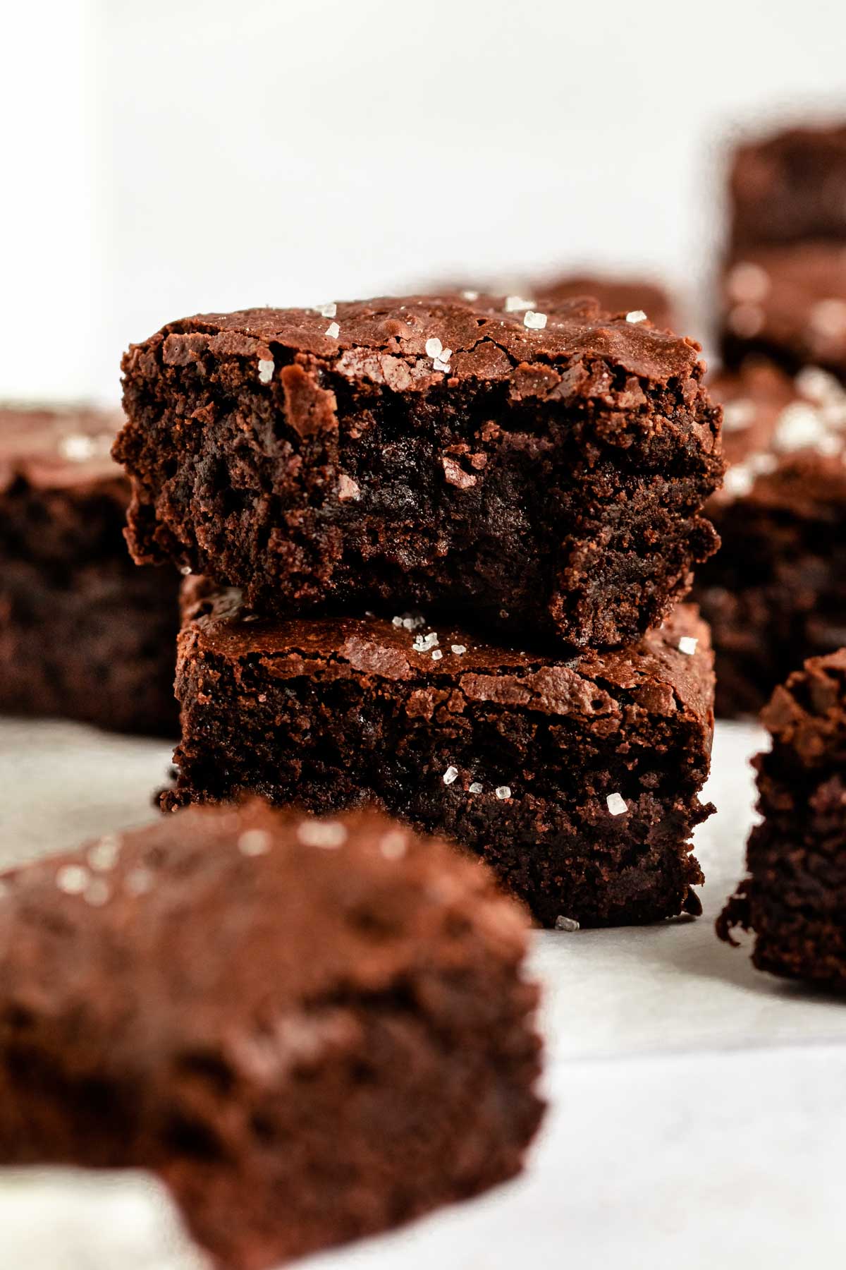 Stack of small batch brownies with the top one missing a bite.