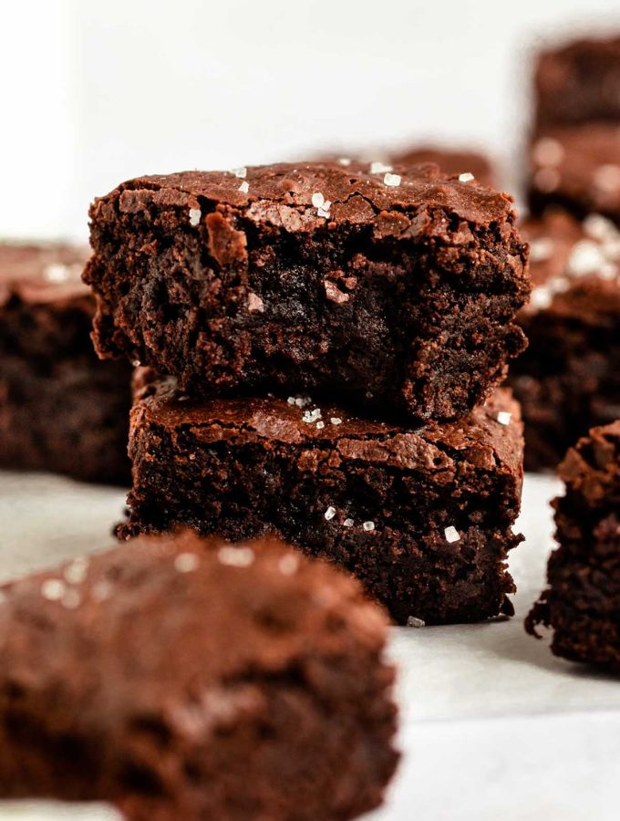 Stack of small batch brownies with the top one missing a bite.