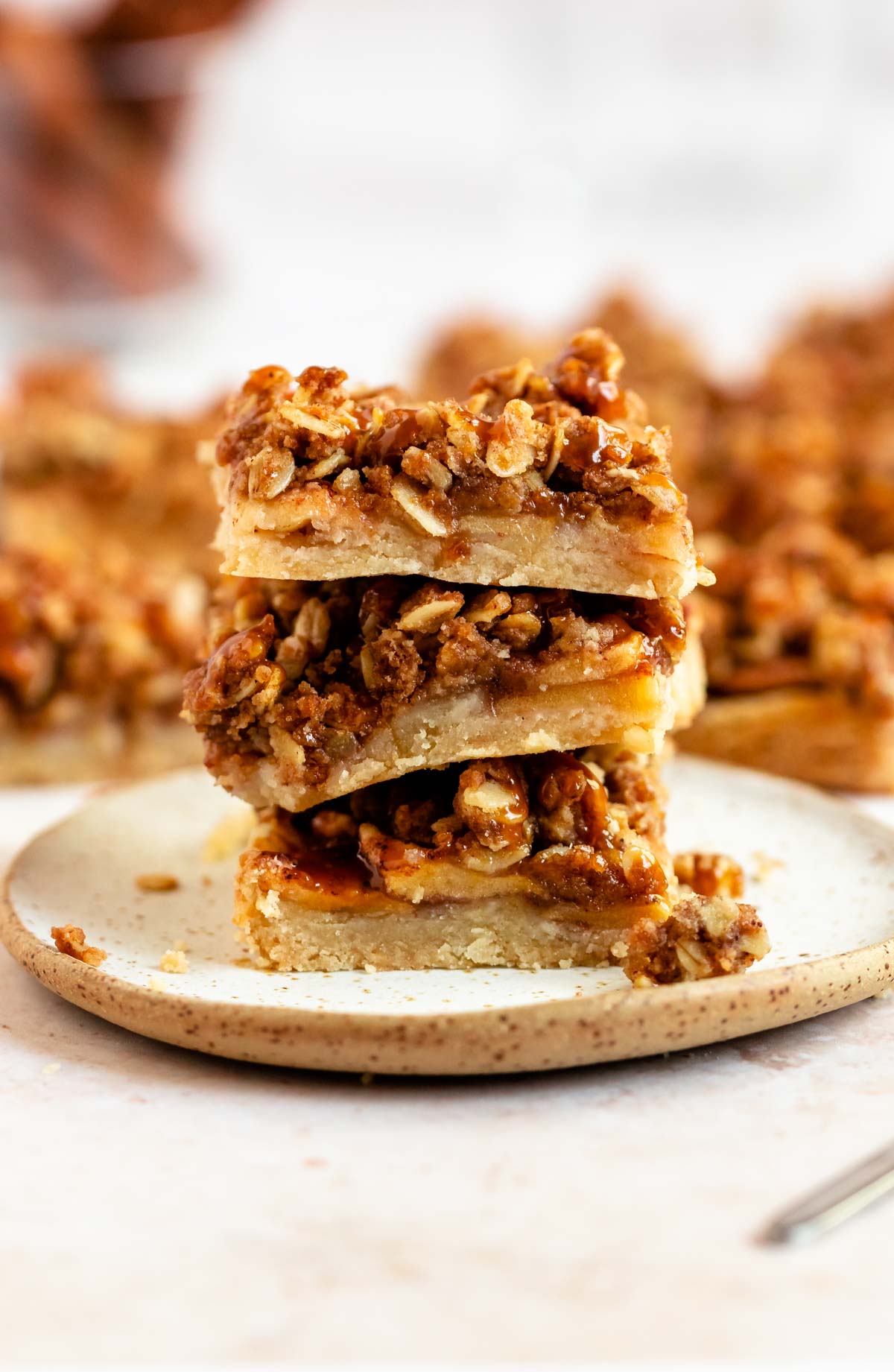 Stack of apple bars on a plate.