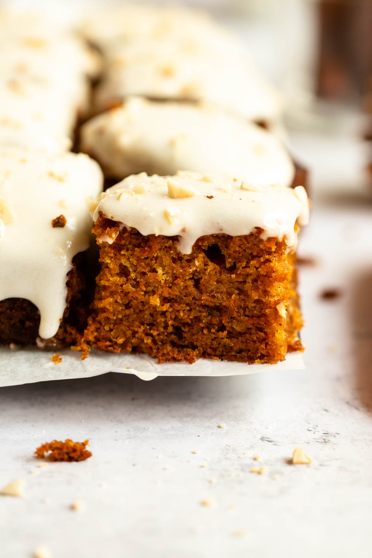 Sliced easy carrot cake on a parchment paper.