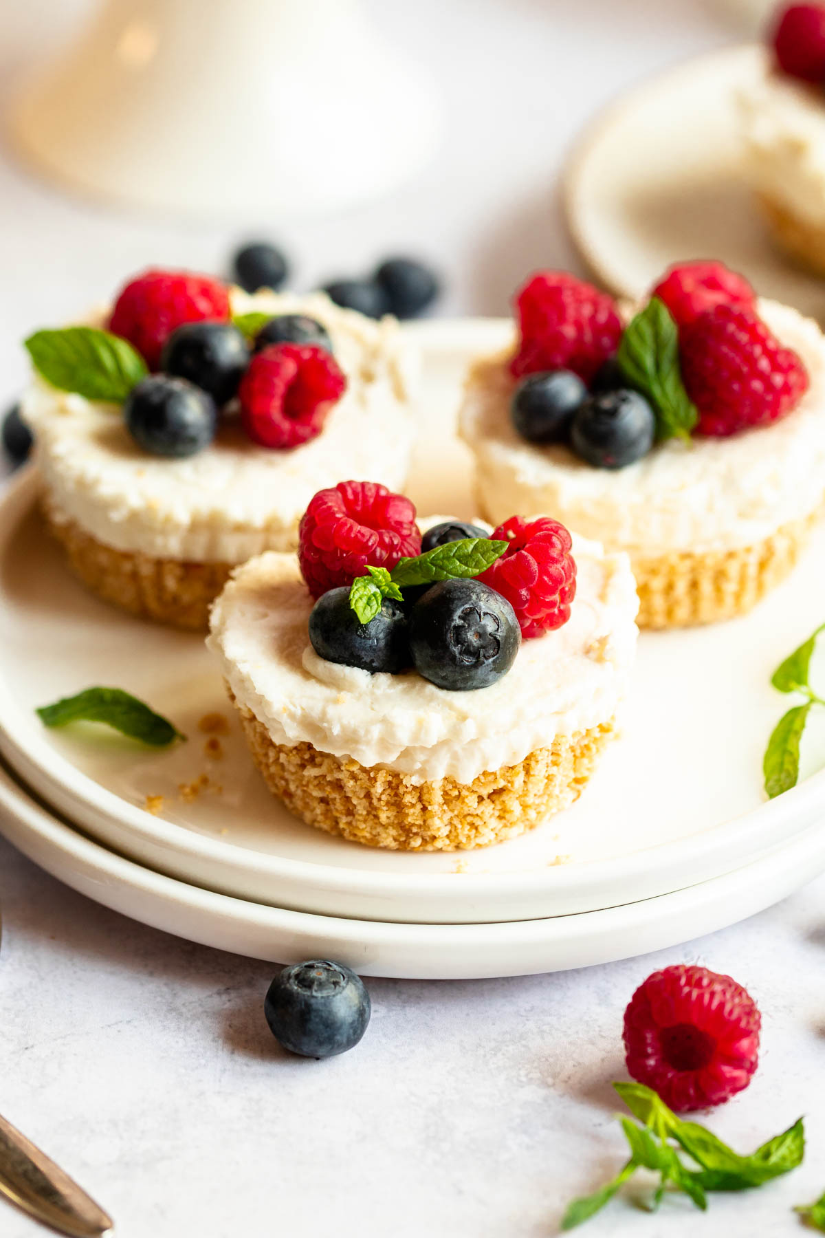 Mini no bake cheesecakes on a plate.