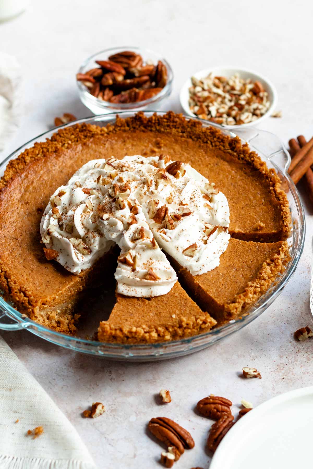 Sliced pumpkin pie with graham cracker crust.