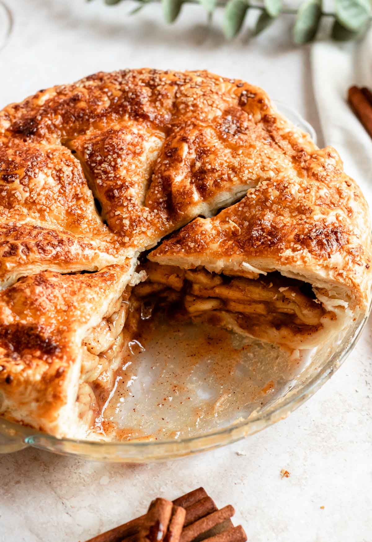 Apple pie with puff pastry with a piece missing.