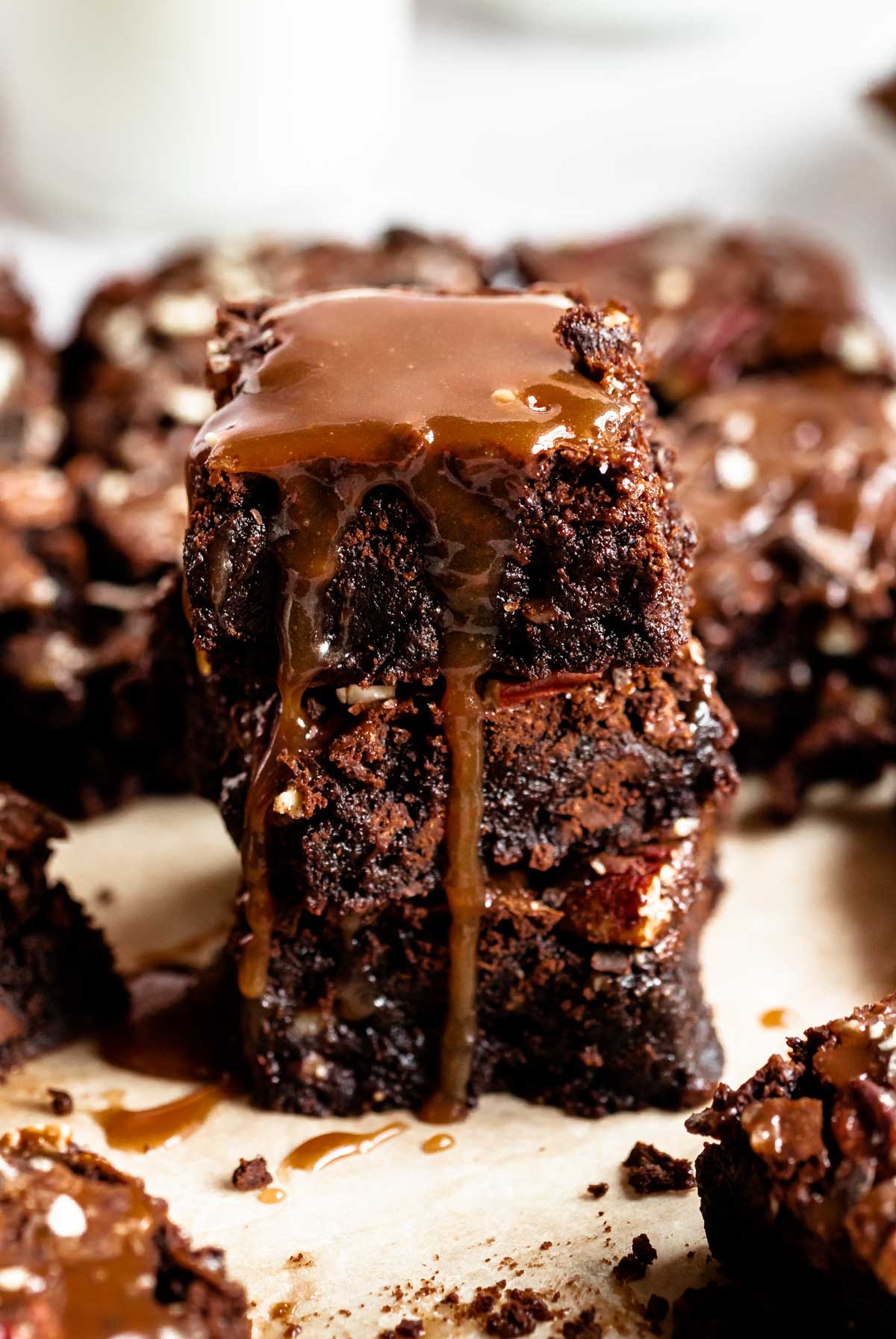Stack of brownies drizzled with caramel sauce.