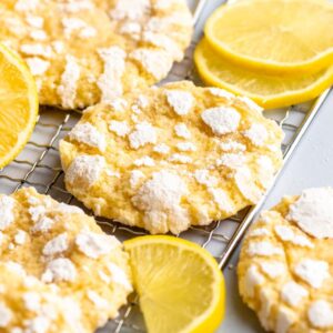 Lemon crinkle cookies on a cooling rack.