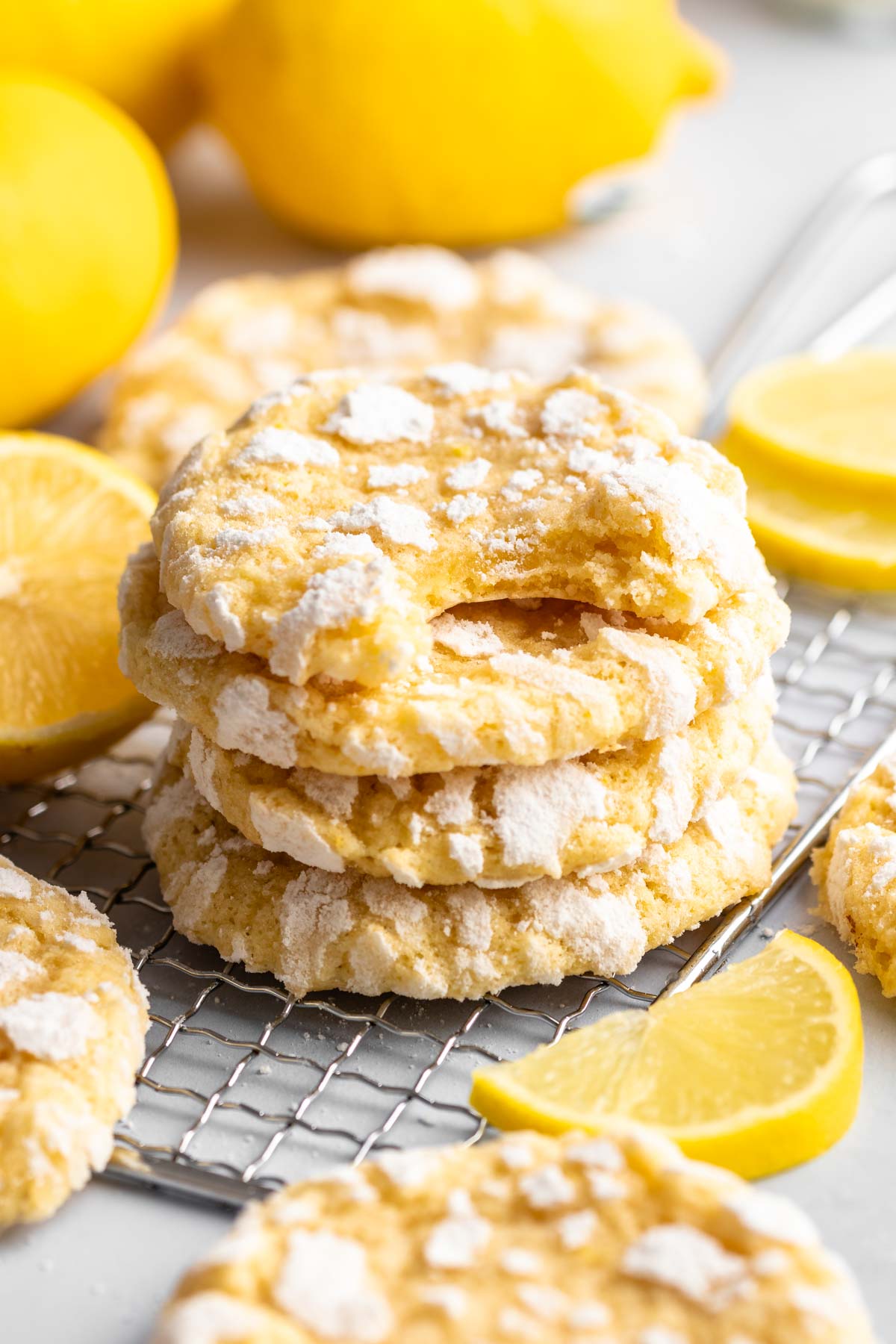 Stack of lemon cookies with the top one missing a bite.