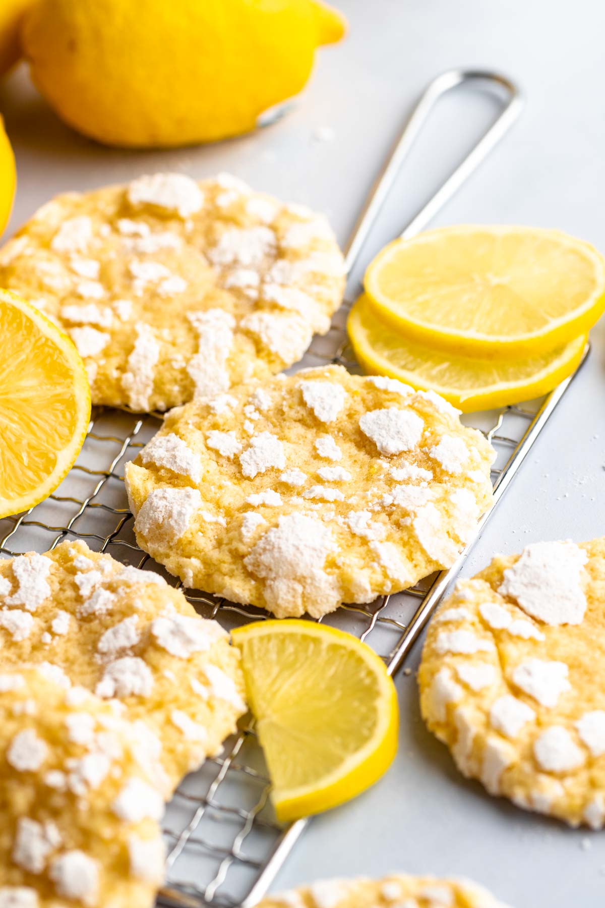 Lemon crinkle cookies on a cooling rack.