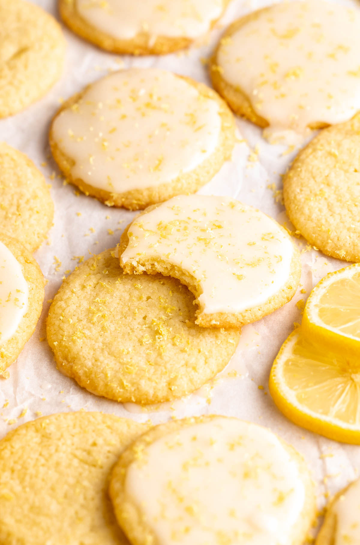 Bite missing from a lemon shortbread cookie.