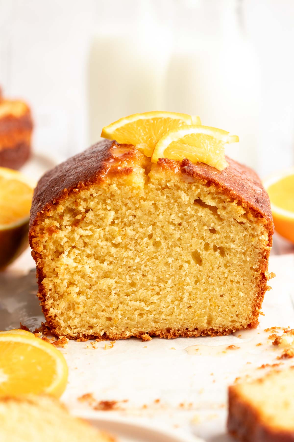 Orange pound cake cut open with a slice of orange on top.