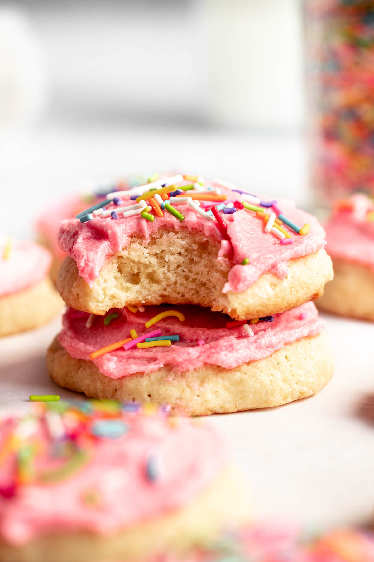 Stack of two cookies with the top one missing a bite.