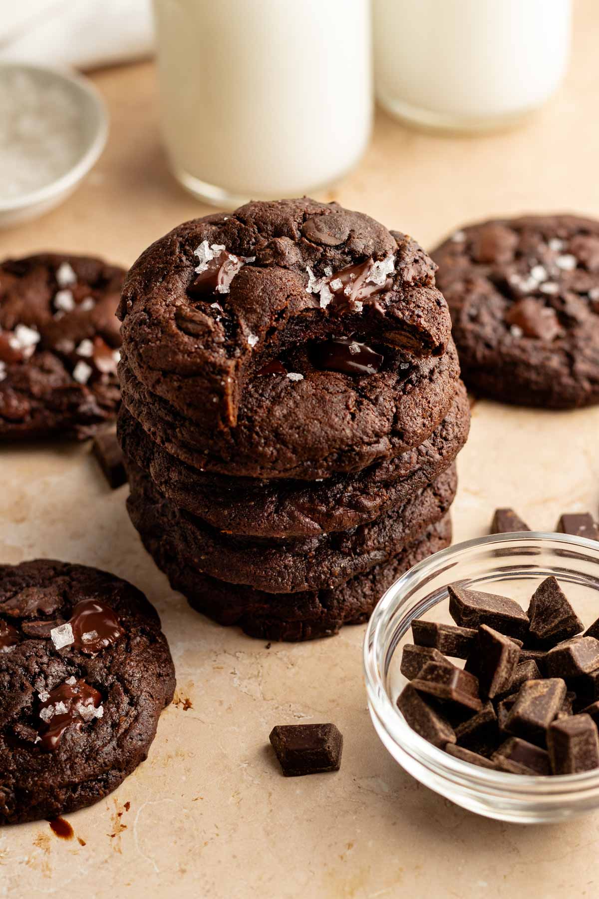 Stack of chocolate cookies with the top one missing a bite.