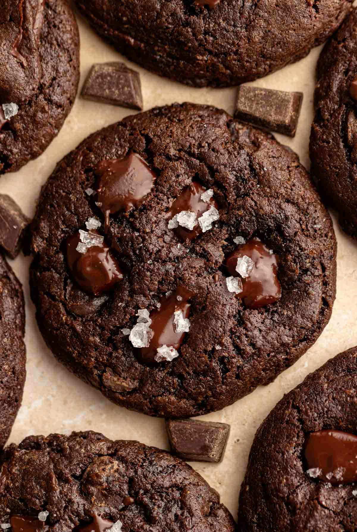 Close up shot of triple chocolate cookies with flakey salt on top.