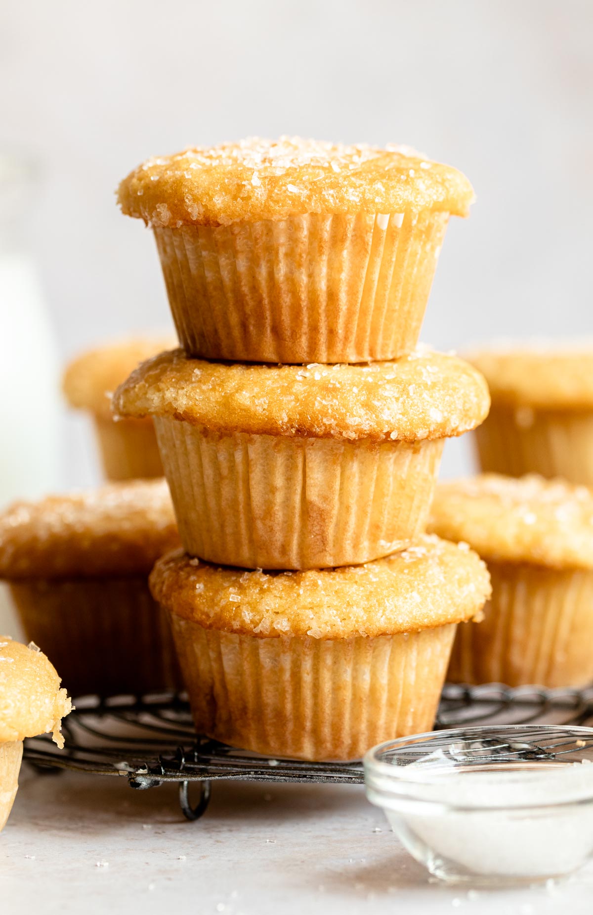 Stack of vanilla muffins on a cooling rack.