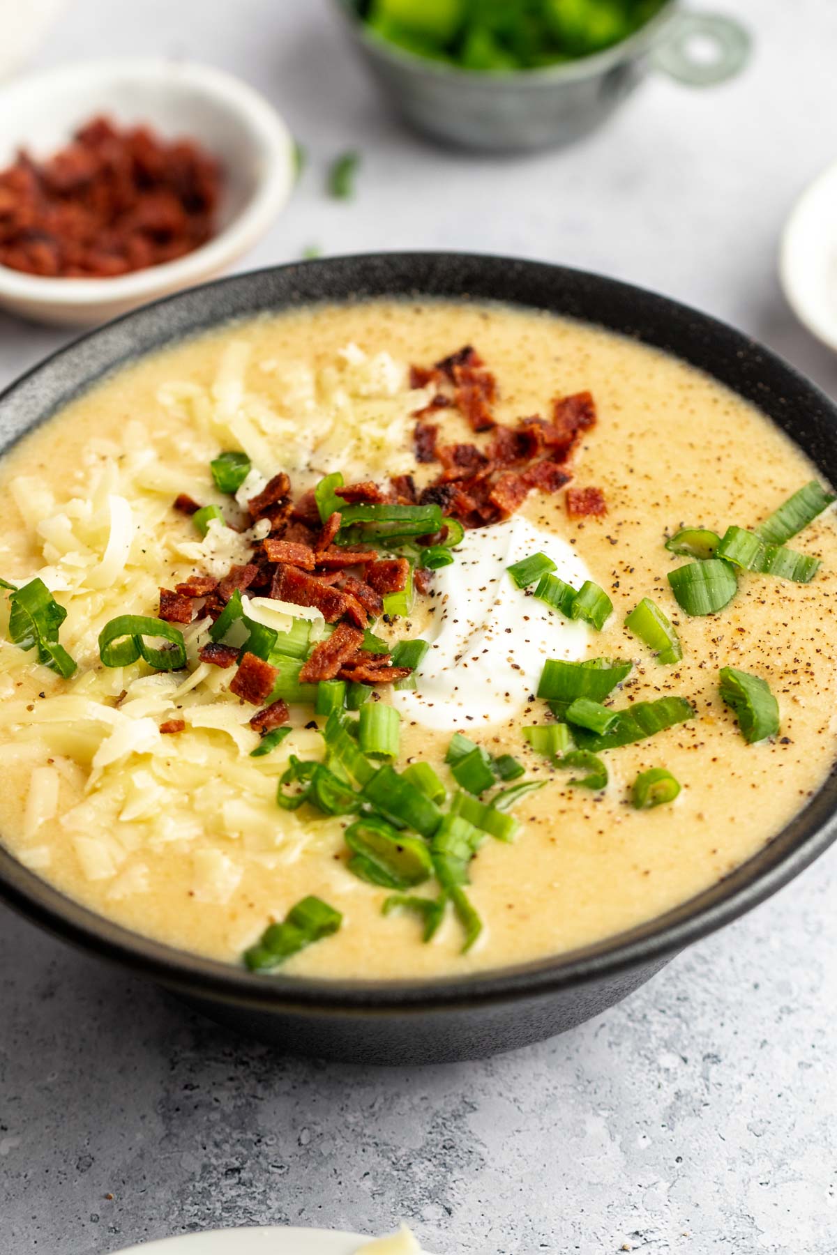 Close up shot of simple potato soup with chopped bacon.