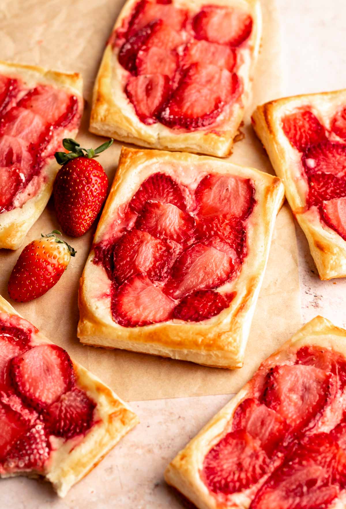 Strawberry cheese danish on parchment paper.
