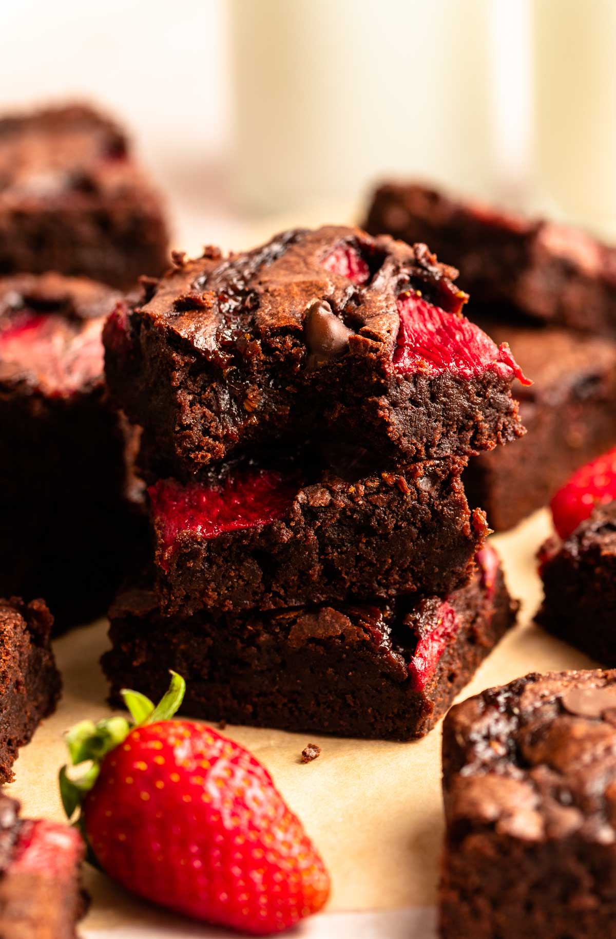 Stack of strawberry brownies with the top one missing a bite.