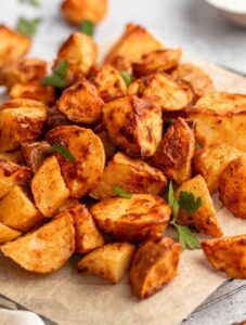 Close up shot of air fryer home fries on a parchment paper.