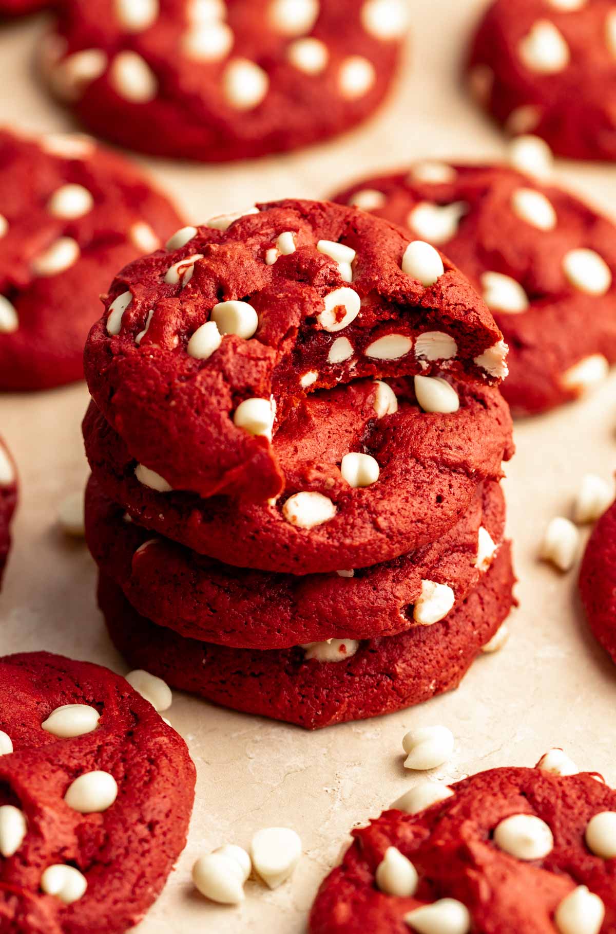 Stack of red velvet cookies with cake mix with a bite missing from the top cookie.