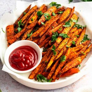 Carrot fries in a large white plate.