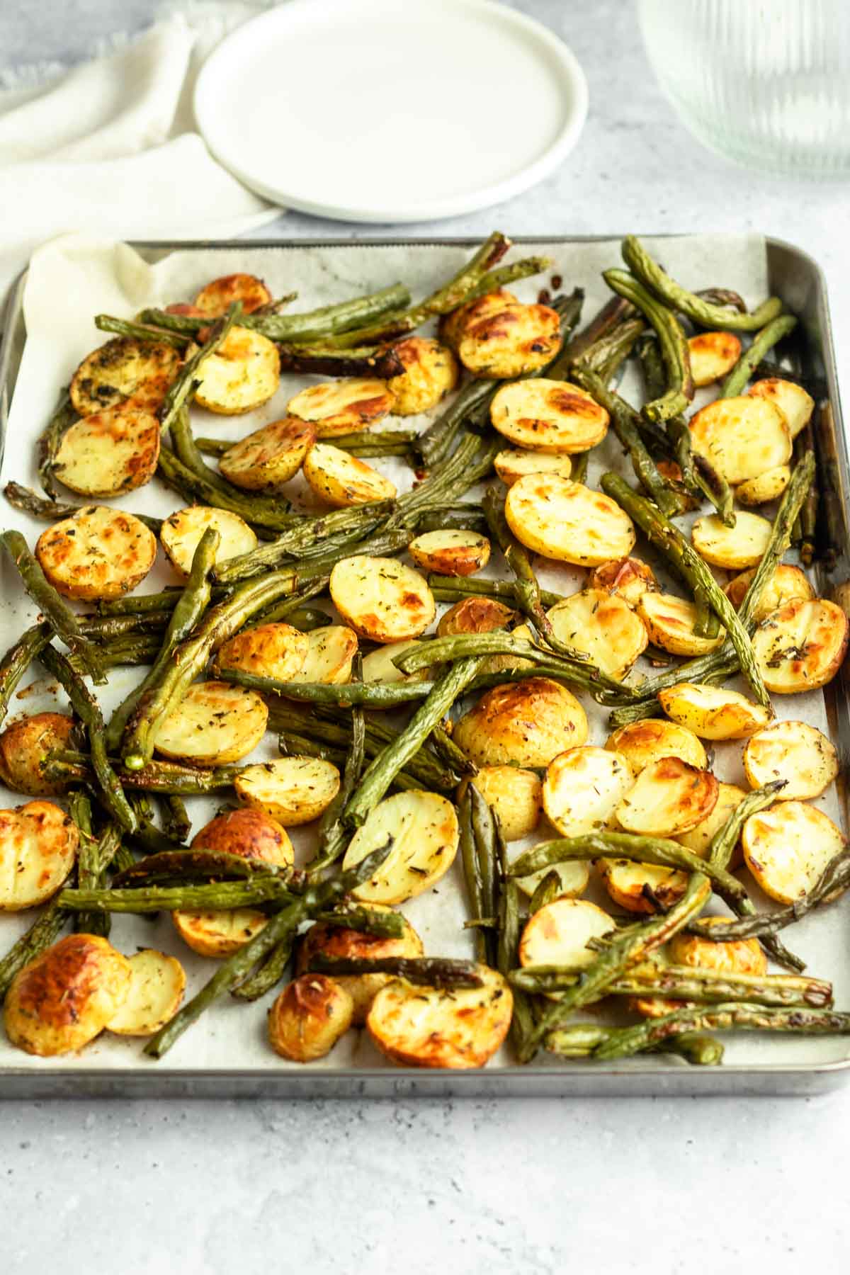 Sheet pan with green beans and potatoes.