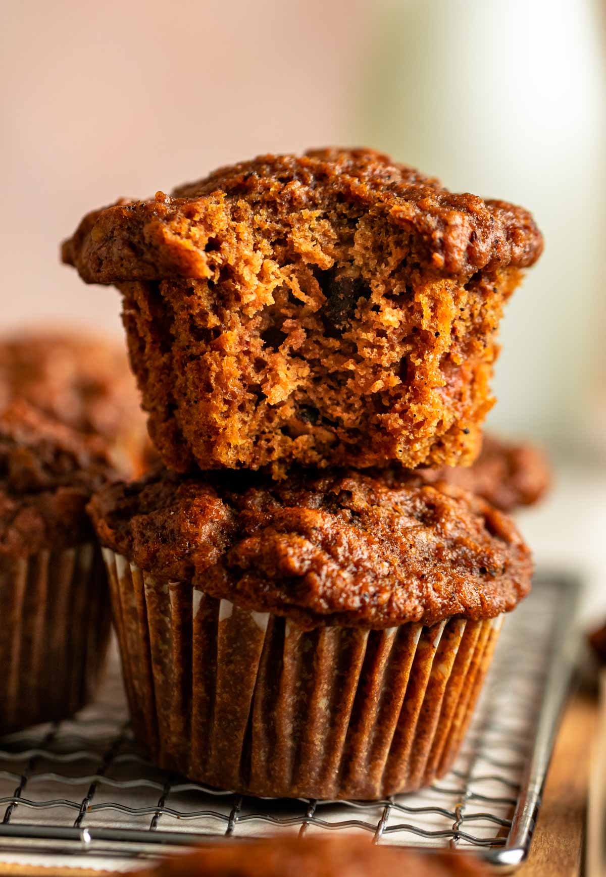 Stack of two healthy breakfast muffins with the top one missing a bite.