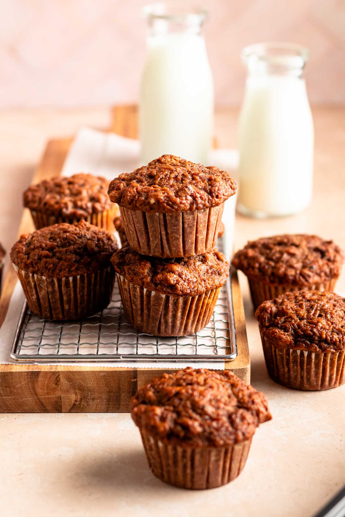 Stack of muffins on a wooden board.