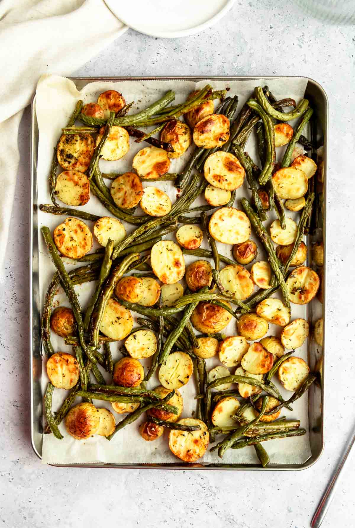 Top of potatoes and green beans on a sheet pan.