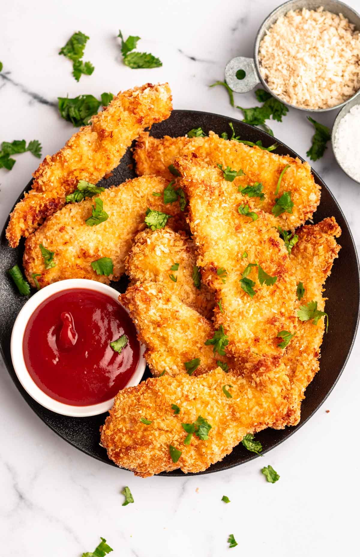 Overhead shot of air fryer chicken tenders on a plate.